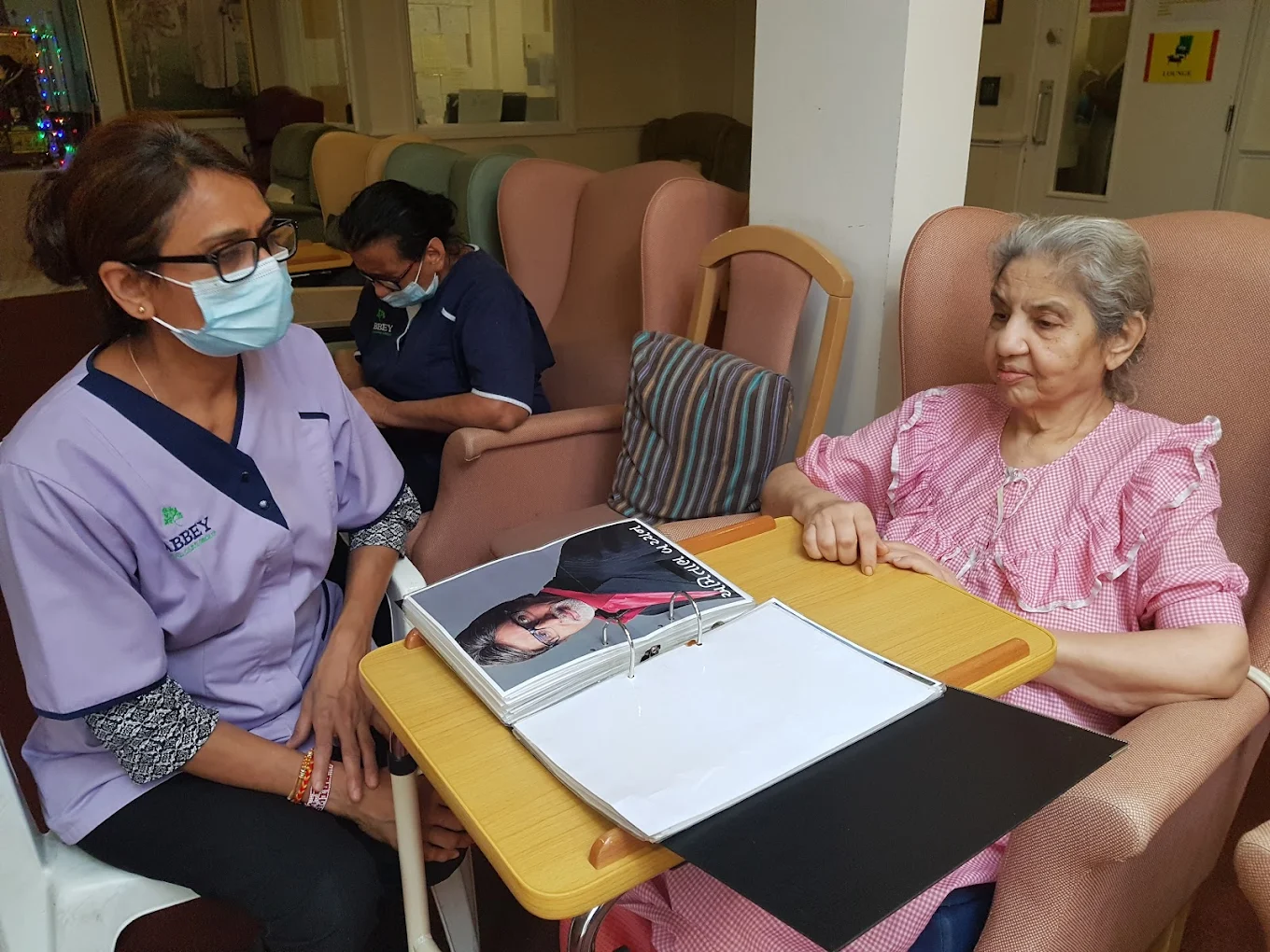 Staff member engaging in memory activities with a resident